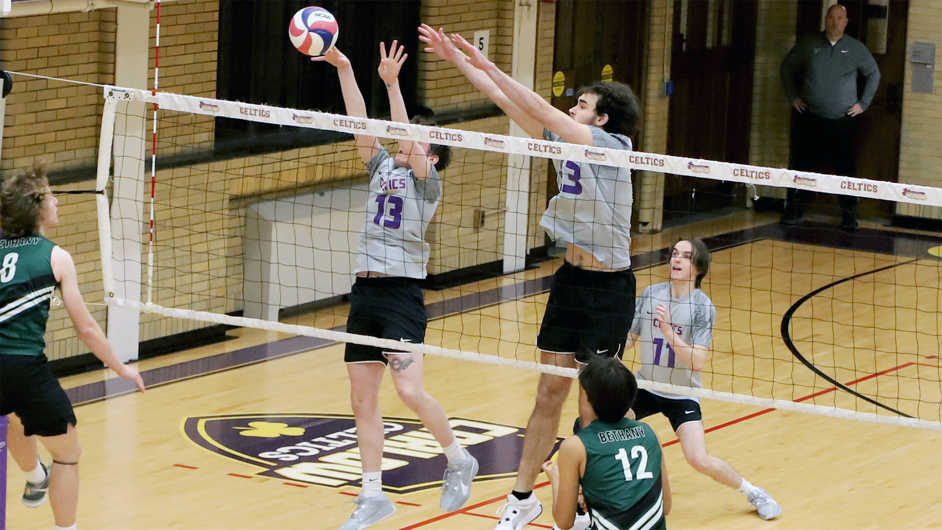 From left: James Stone and Gavin McLain go up for the block. Photo by Robert Cifone.